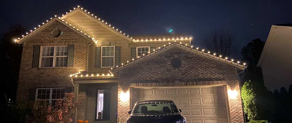 Holiday lights hung around perimeter of a home in Carmel, IN.